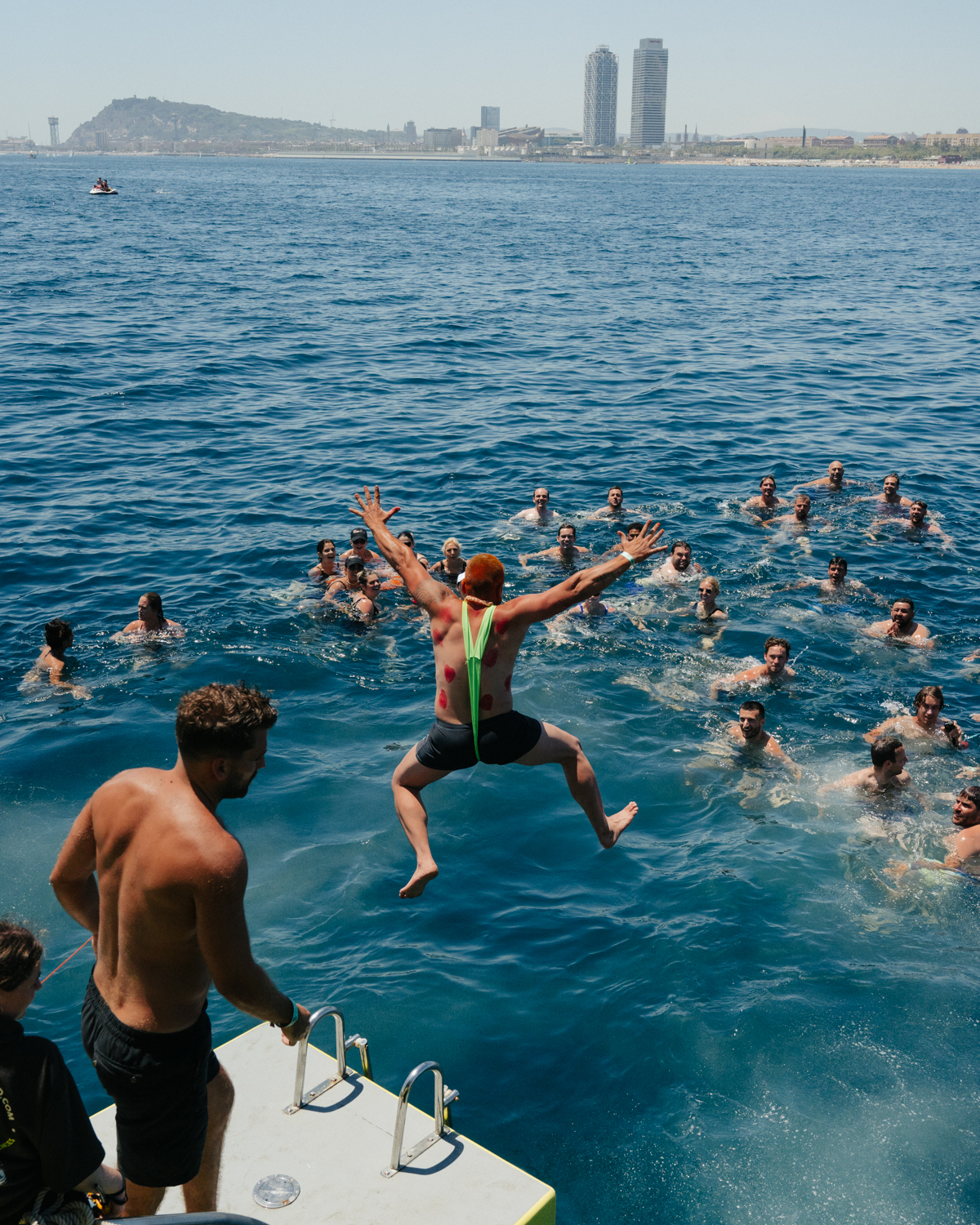 Snacks and Swim_8 man jumping from barcelona boat party in a mankini